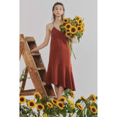 Silk slip dress with flared hem and double-strap open back for a sleek, modern silhouette